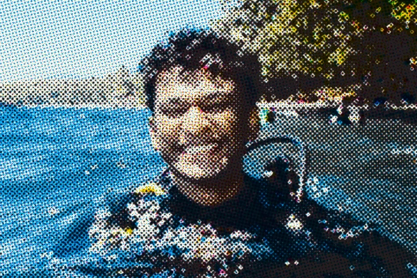 Shreyas in a scuba dive suit, smiling